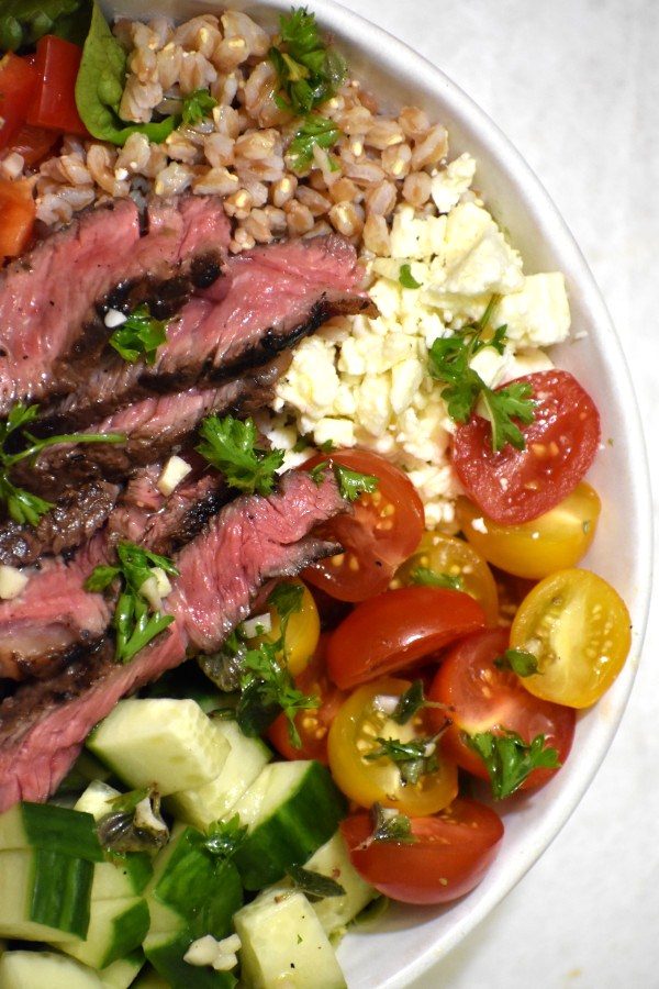 close up of greek steak salad bowl viewed from above