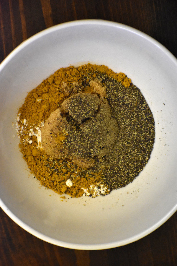 bowl with flour, brown sugar, black pepper and curry powder