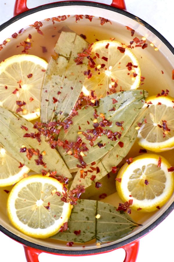 Potful of water seasoned with lemon, bay leaves, red chili flakes and salt.